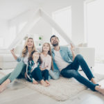 Photo of young family adopted two children move new apartments hold hands paper roof hoping best future