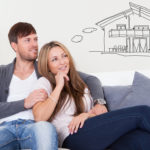 Cheerful young couple dreaming about the future